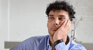 Sjedenje na kauču i držanje lica pri razmišljanju