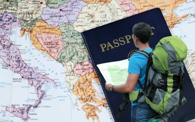 Karta Europe i turist s kartom u rukama i ruksakom na leđima