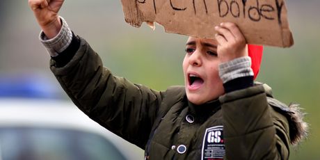 Migranti drže plakate