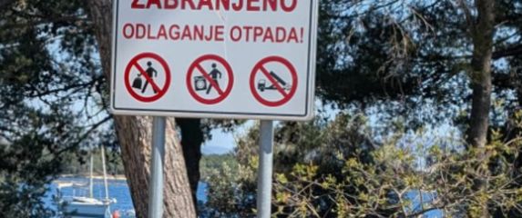 Deponij ispod znaka za zabranu odlaganja otpada