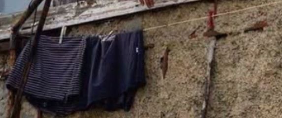 Muškarac na prozoru kako peče roštilj