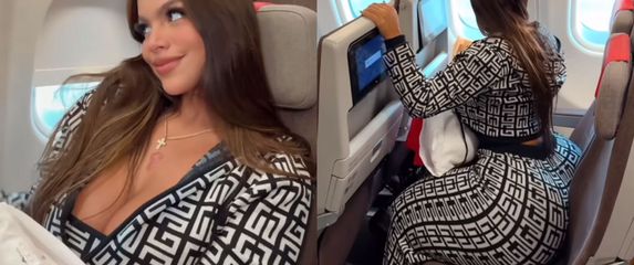Plus size manekenka Gracie Bon kako sjedi u avionu na dva sjedala i pozira za kameru