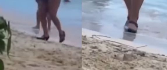 Žena na plaži u visokim petama