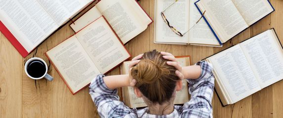 Žena ispred otvorenih knjiga