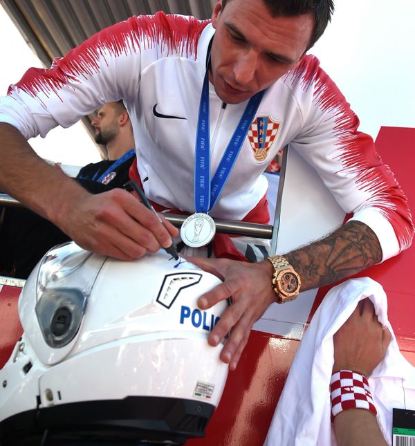Mario Mandžukić potpisuje kacigu policajcu