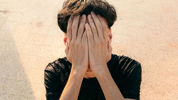 Dečko prekriva lice