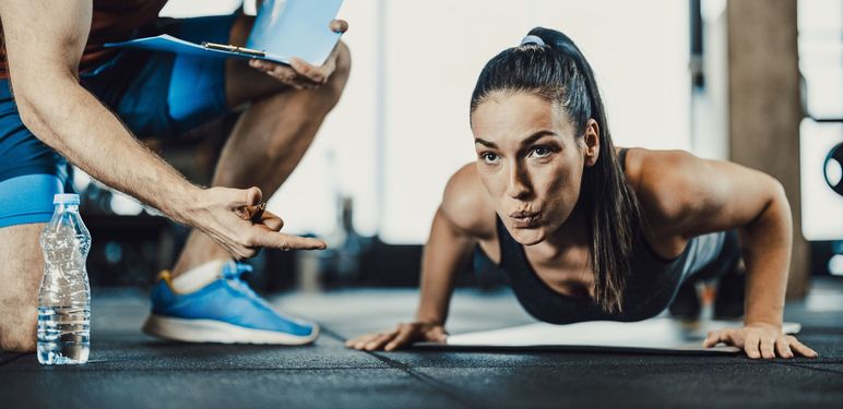 Žena koja radi sklekove u teretani