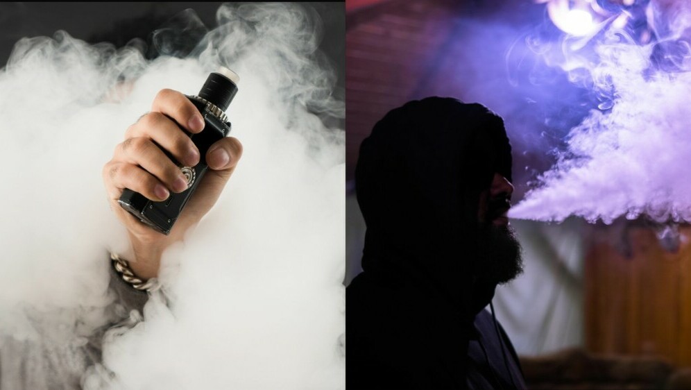 Elektronička cigareta u ruci u oblaku dima i muškarac koji ispuhuje dim