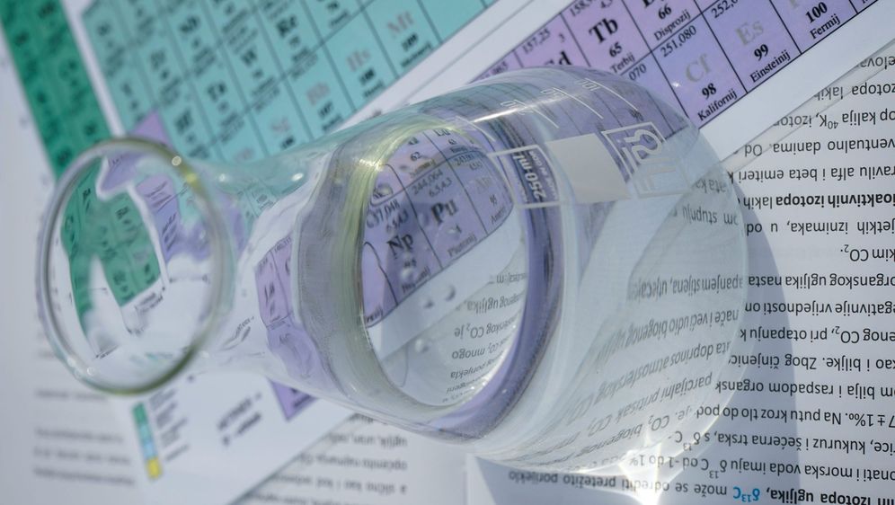 erlenmayerova tikvica koja stoji na periodnom sustavu elemenata i predstavlja kemiju